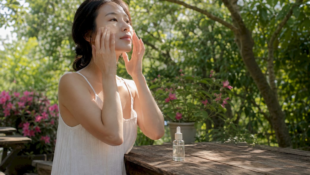 Woman applying serum for skin hydration