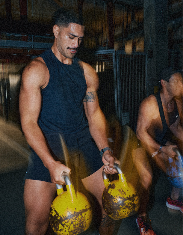 Man training with kettlebells in a gym