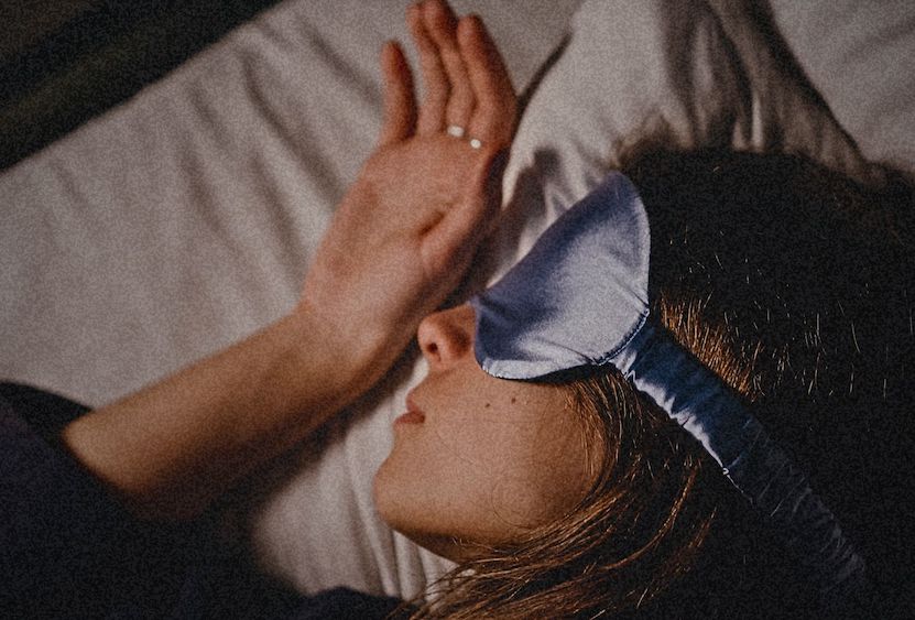 Woman resting with a sleep mask on