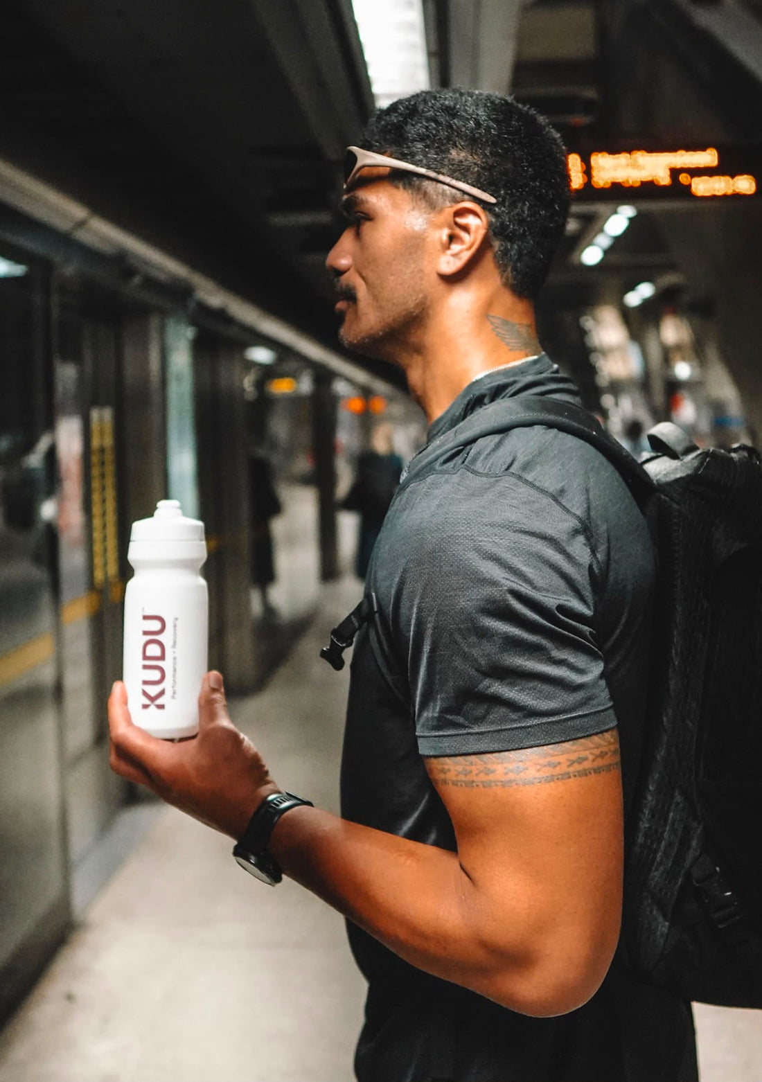 Man with a KUDU bottle on the commute